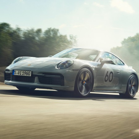 A Porsche 911 with the number 60 painted on the side speeding down the road