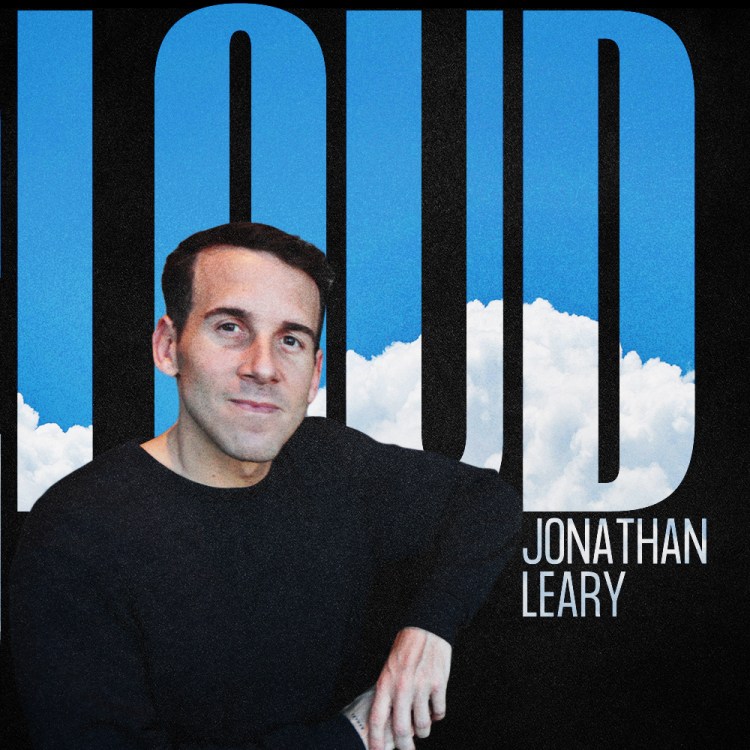 Jonathan Leary, CEO of Remedy Place, in a black sweater with “Cloud 9” text behind him and a backdrop of bright blue sky and clouds