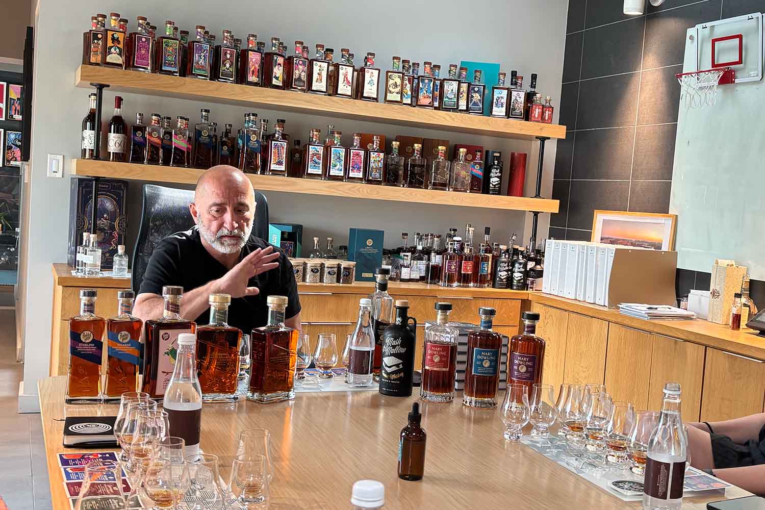 The many expressions of Rabbit Hole distillery, on a wall behind founder Kaveh Zamanian